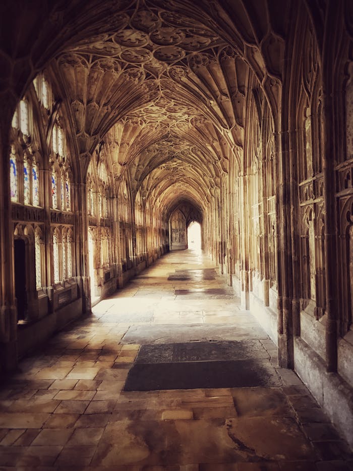 services-02 Explore the detailed Gothic architecture of the historic cloister at Gloucester Cathedral, England.